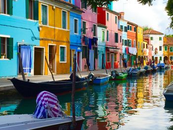 Boats moored in canal in front of buildings in old town