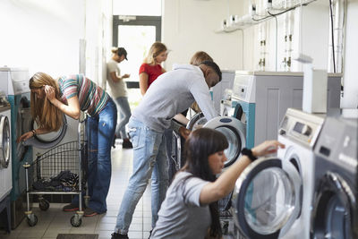 University students using washing machines at campus laundromat