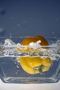 Yellow pepper splashing into water