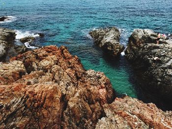 High angle view of rock formation by sea