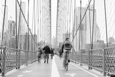 People walking on bridge in city