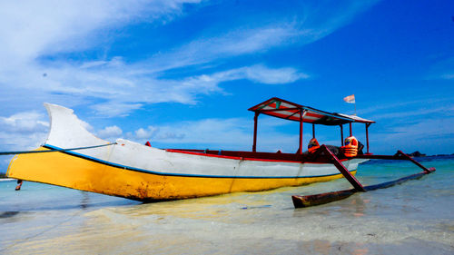 Low angle view of boat on beach against sky