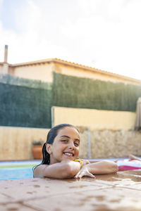 Funny kid smiling on a pool side