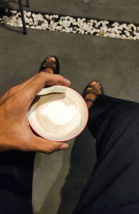 Midsection of woman holding coffee cup