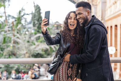 Smiling couple doing selfie outdoors