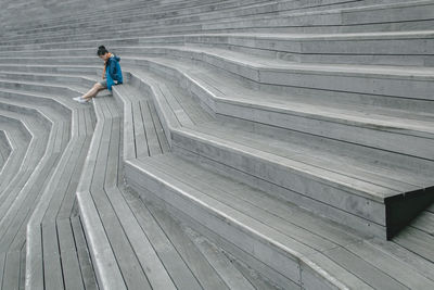 Full length of woman standing by railing