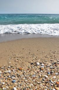 Pebbles on beach against sky