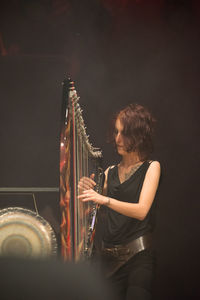 Rear view of woman sitting at music concert