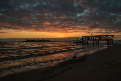 Scenic view of beach against sky during sunset