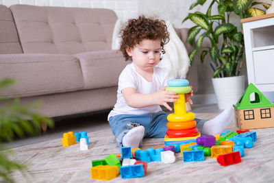 Cute girl playing with toy blocks