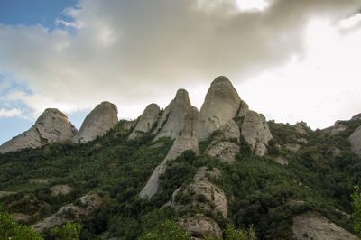 Scenic view of rocky mountains against cloudy sky