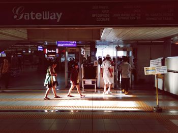 People walking on railroad station platform