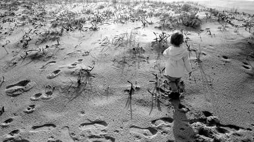 Rear view of woman walking on beach