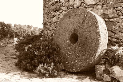 Close-up of stones on rock against sky