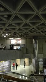 People walking in corridor of building