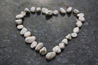 High angle view of heart shape stone on pebbles