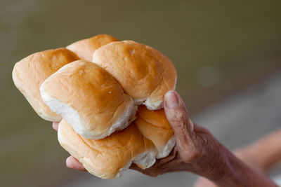 Close-up of hand holding burger