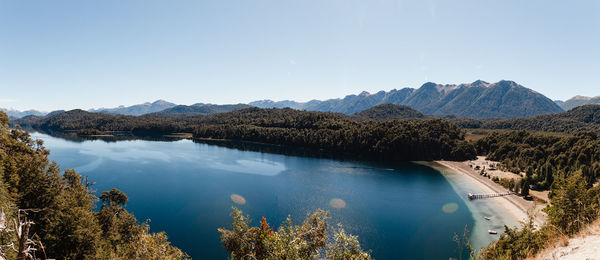 Scenic view of lake and mountains against clear sky