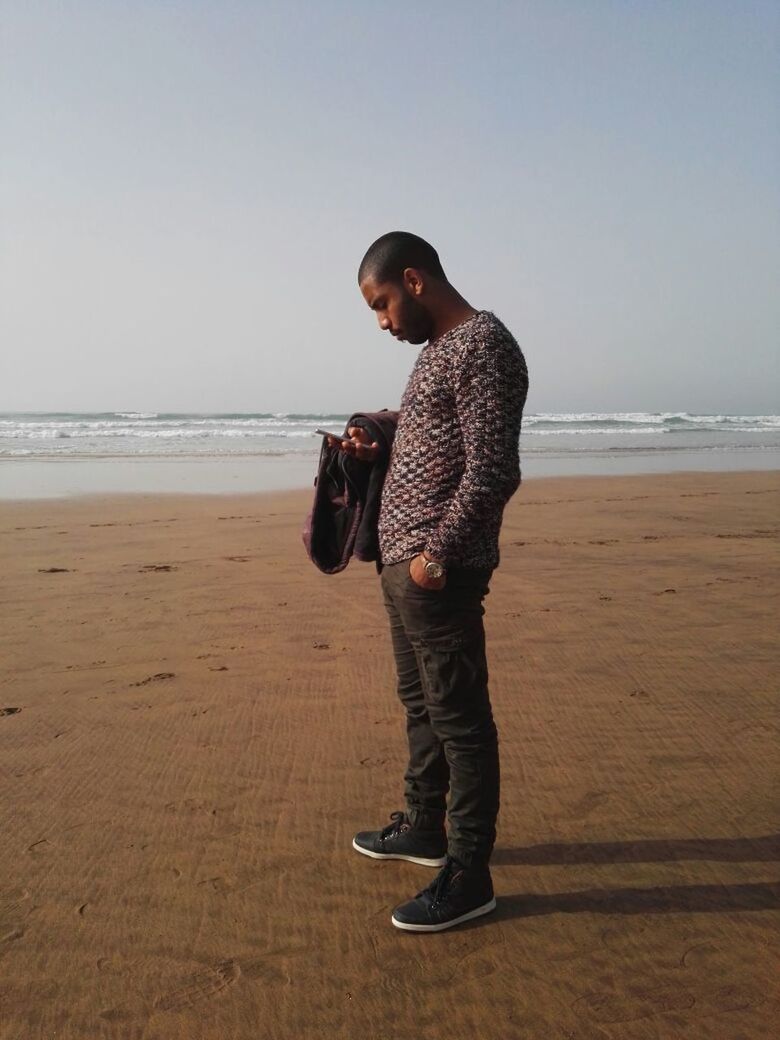 FULL LENGTH OF MAN STANDING ON BEACH