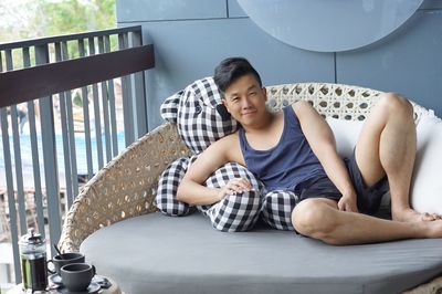 Portrait of young man sitting on seat