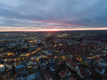 Aerial view of illuminated cityscape against sky