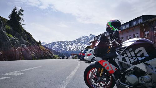 Vehicles on road against mountain range