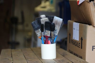 Paintbrushes in small container on table