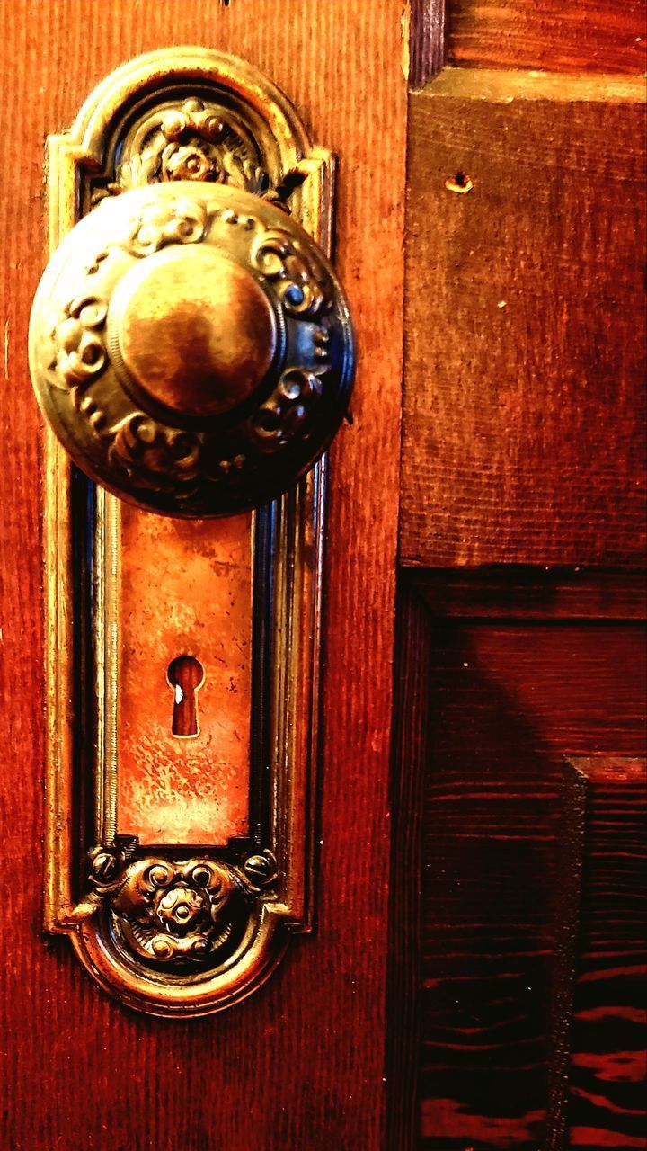 CLOSE-UP OF DOOR HANDLE ON WOODEN TABLE