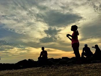 Silhouette of people at sunset