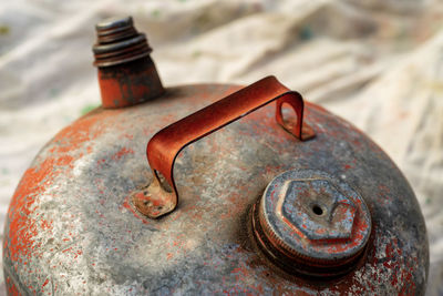 Antique metal gas can peeling red paint