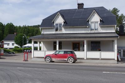 Car on street against buildings in city