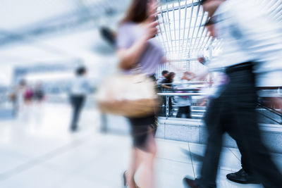 Blurred motion of people walking in city