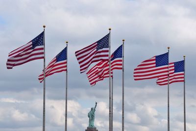 American flag against statue of liberty