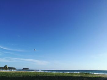 Scenic view of sea against blue sky