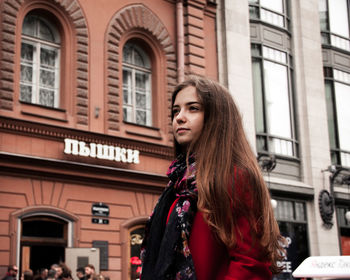 Portrait of beautiful woman standing in city