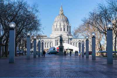 View of city street and buildings against sky