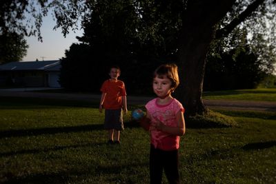 Portrait of happy girl standing on field