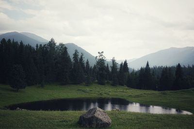 Scenic view of lake and mountains against sky