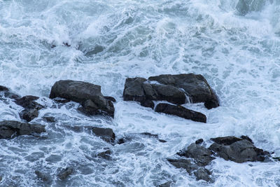 Waves splashing on rocks at shore