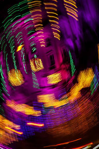 Close-up of illuminated ferris wheel at night