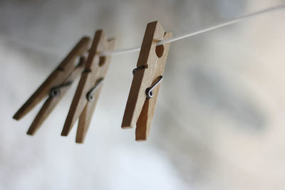 Close-up of clothespins hanging on clothesline