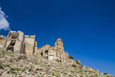 Low angle view of historic building against blue sky