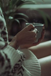 Close-up of hand holding cigarette