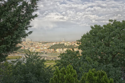 High angle view of trees and buildings against sky