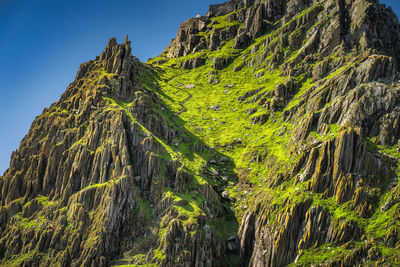 Steep stairs carved in stone on skellig michael island where star wars were filmed, ireland