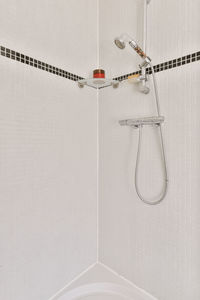 Shower hanging on wall at home