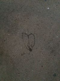 Directly above shot of heart shape on sand