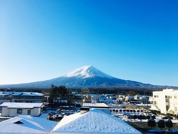 View of snowcapped mountain against blue sky