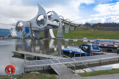 View of boats moored in river against sky