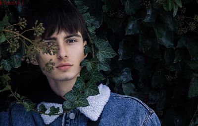 Portrait of man against plant